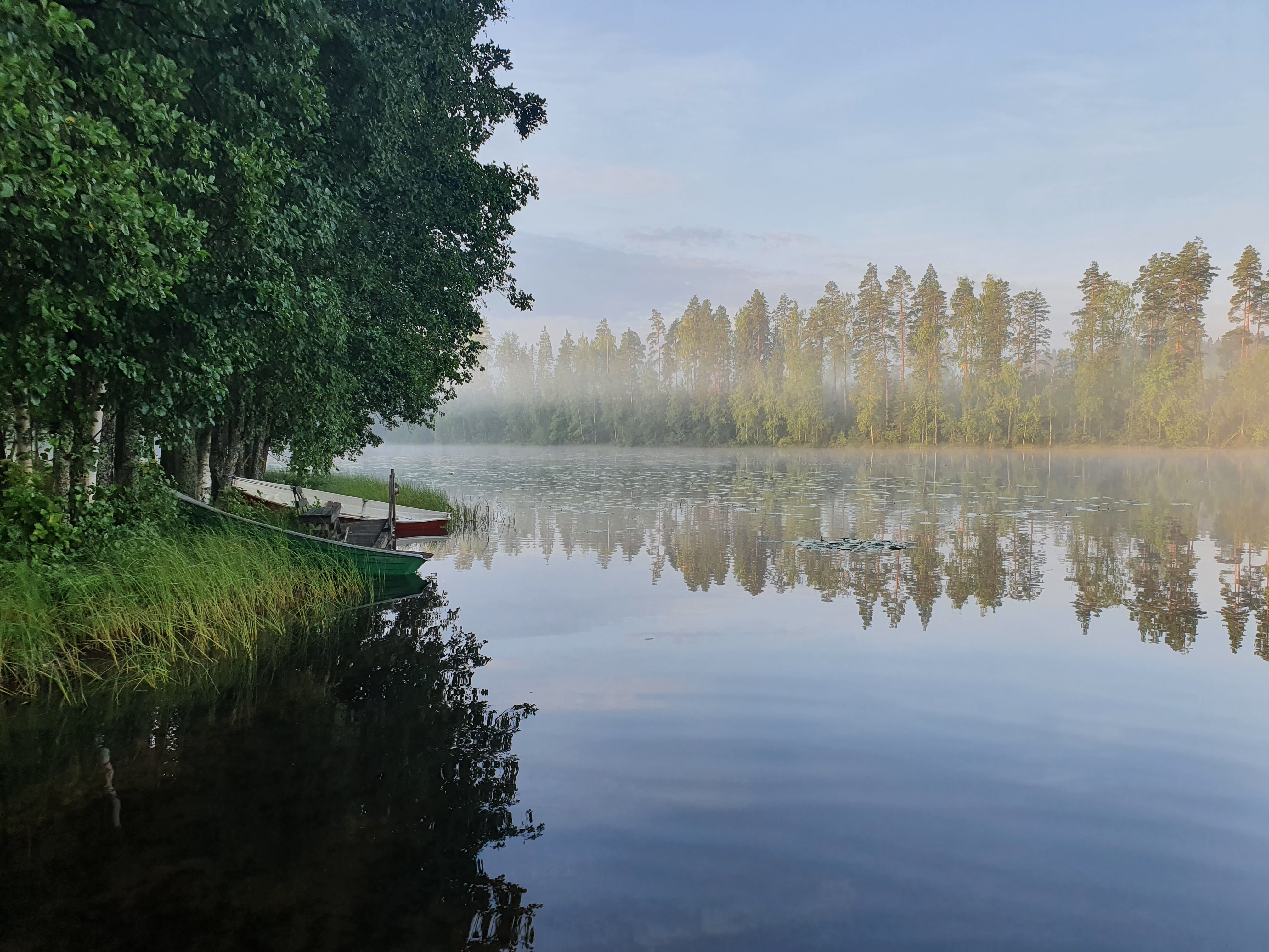 Lake in Finland in summer, with boat tied up to jetty